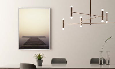 A minimalistic dining space, with a photo framed with a simple metal frame A minimalistic dining space, with a photo framed with a simple metal frame