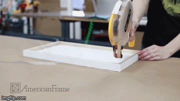 A gif of applying atg tape to the back of a frame A gif of applying atg tape to the back of a frame