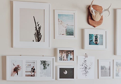 A gallery wall with white frames and white matboards A gallery wall with white frames and white matboards