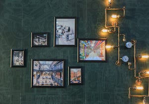 Gallery wall in an industrial space with custom black wood picture frames. Gallery wall in an industrial space with custom black wood picture frames.