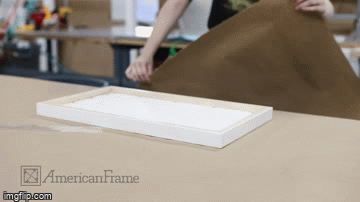 Putting kraft backing paper on a frame and trimming it with a dust cover trimmer Putting kraft backing paper on a frame and trimming it with a dust cover trimmer