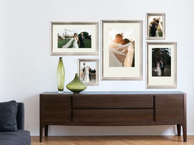 Wall of framed wedding photographs in silver wood frame Wall of framed wedding photographs in silver wood frame
