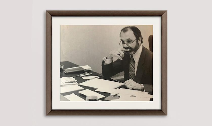 Ron Mickel sitting at his desk in the early days of American Frame