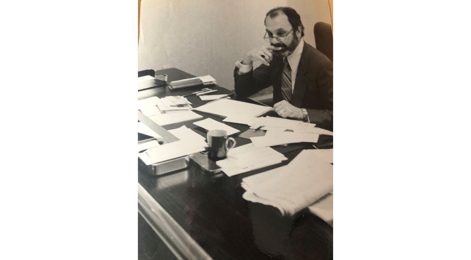 Ron Mickel, founder of American Frame, at his desk in the 1970's