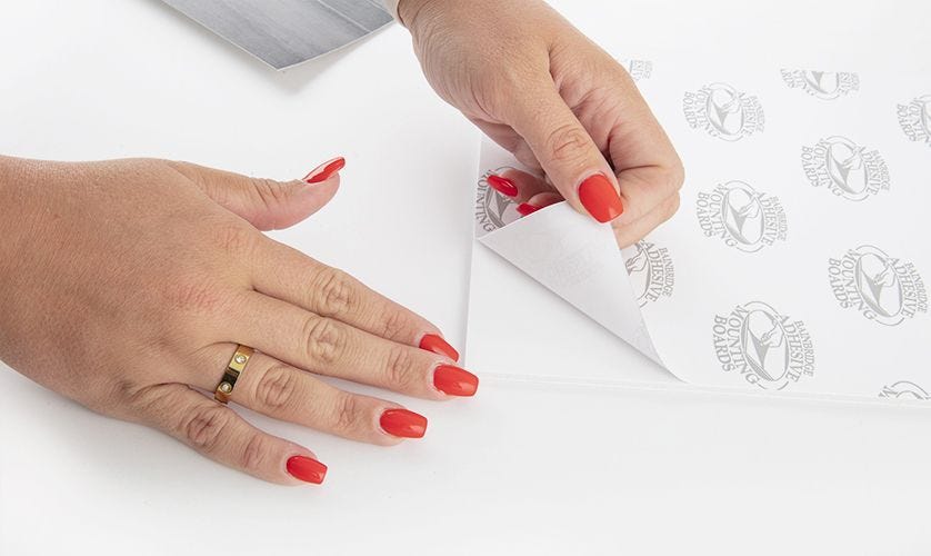 Peeling the liner of self-adhesive mounting board