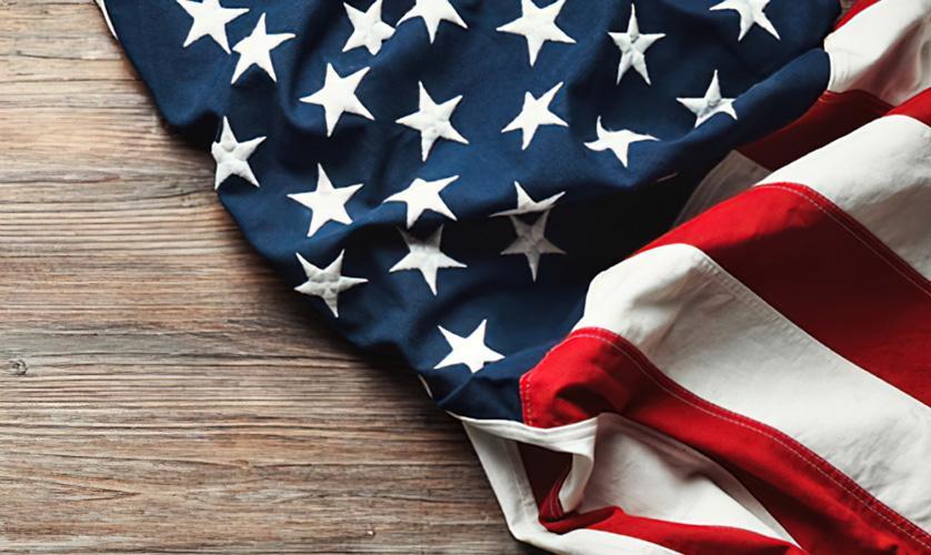United States flag draped across wood tabletop