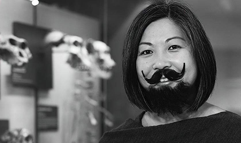 Black and white photo of woman with drawn on beard