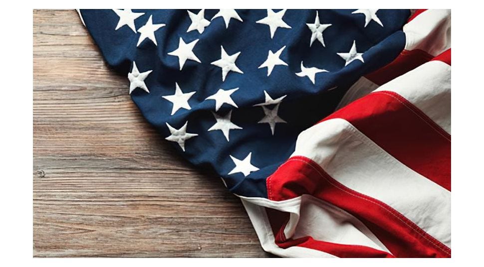 United States flag draped across wood tabletop