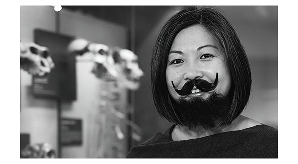 Black and white photo of woman with drawn on beard
