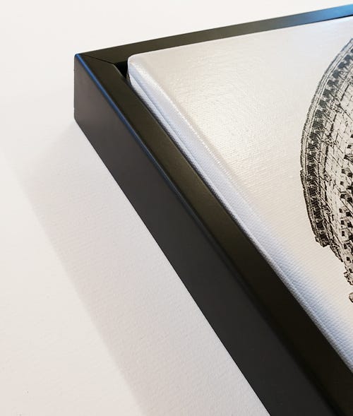 A canvas poking out the front of a frame A canvas poking out the front of a frame