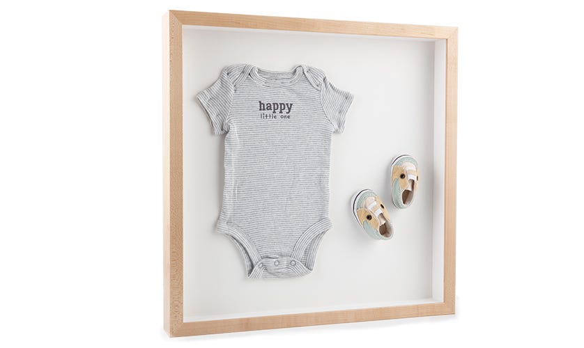 Create a custom shadowbox to display newborn clothes or shoes Create a custom shadowbox to display newborn clothes or shoes
