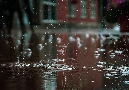 Close up of rain droplets on the street Close up of rain droplets on the street