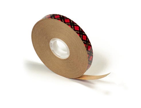 Roll of red adhesive transfer tape for mounting artwork and adhering mat boards together