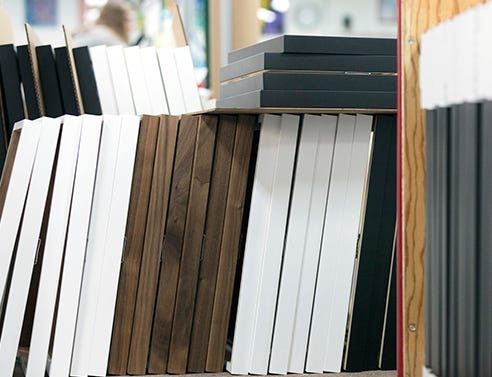 Multiple walnut, white and black wood frames used for large volume orders. 
