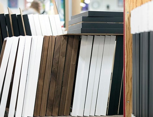 Multiple walnut, white and black wood frames used for large volume orders. 