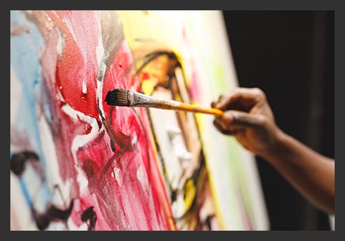 Artist painting on a canvas with acrylic Artist painting on a canvas with acrylic