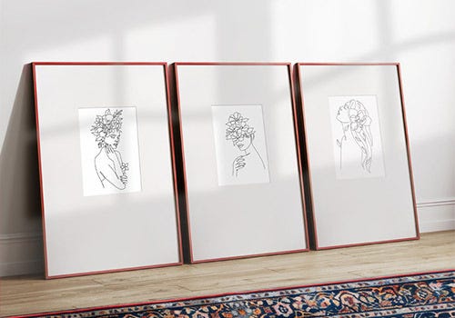 An innovative use of large cool-tone mats around small drawings with red frames.